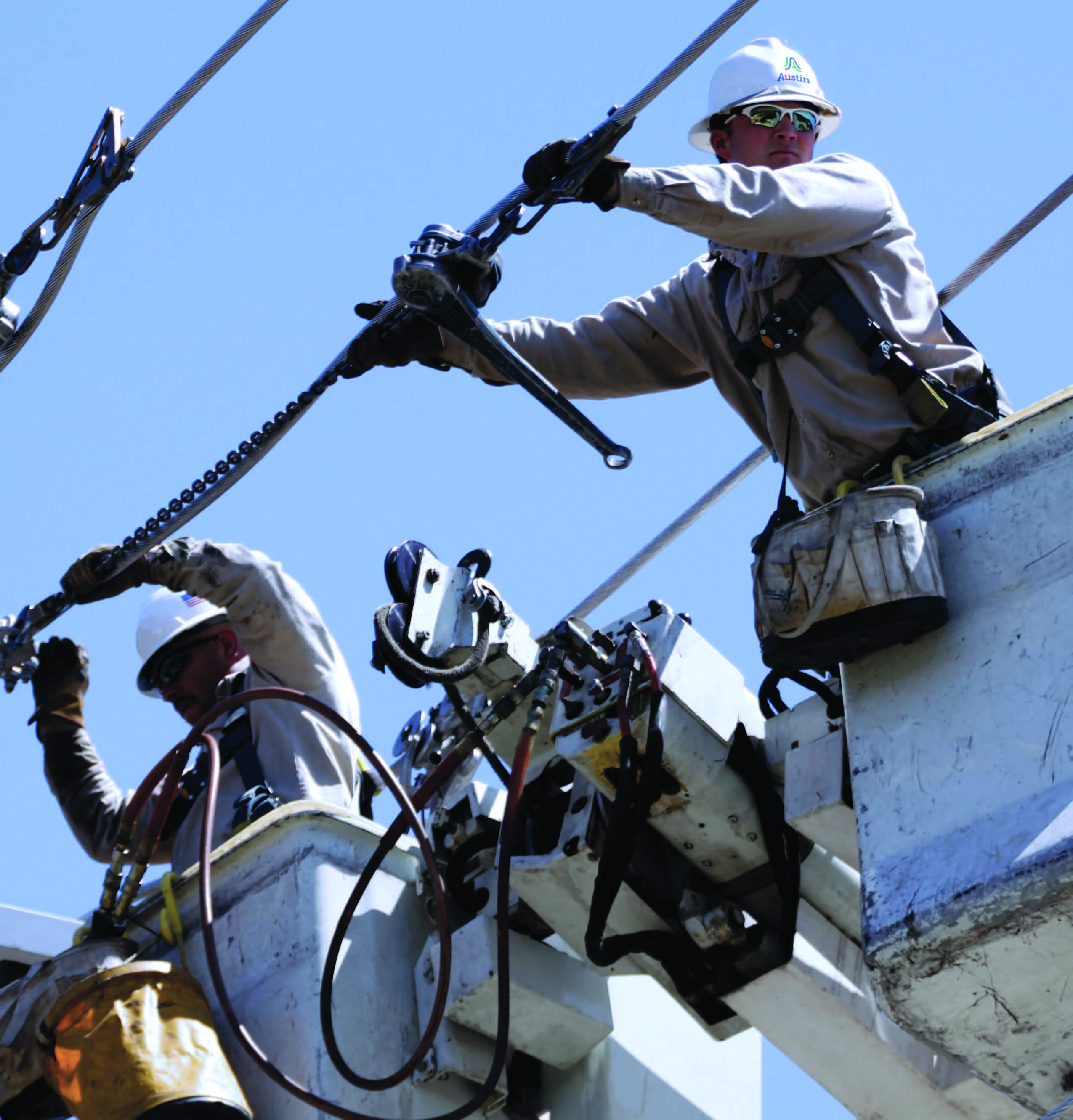 Electric utility line worker working from a bucket truck